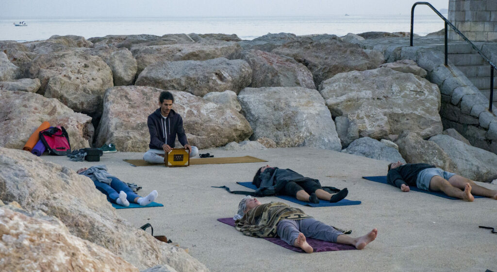 People relaxing on the mat by the sea in Menton