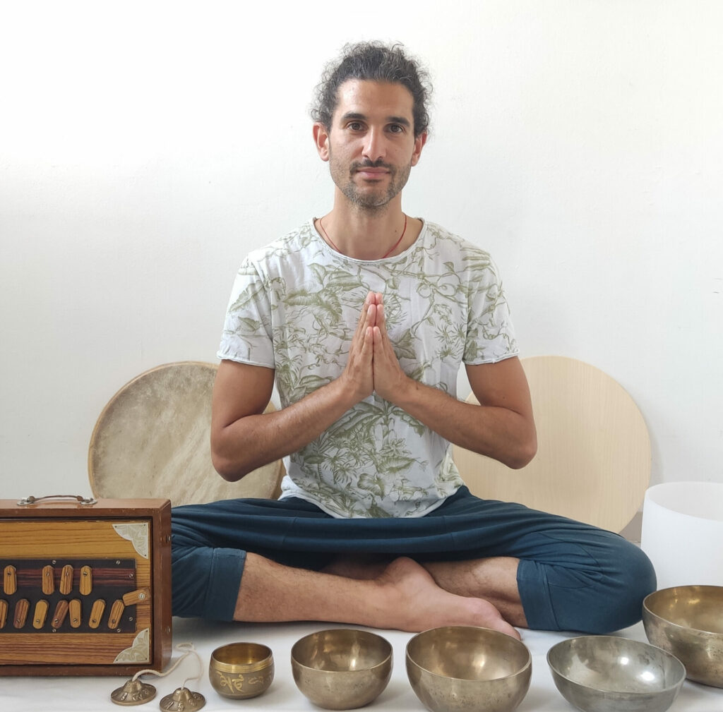 alex sitting with sound healing instruments, the shruti box, singing bowls & shamanic drums